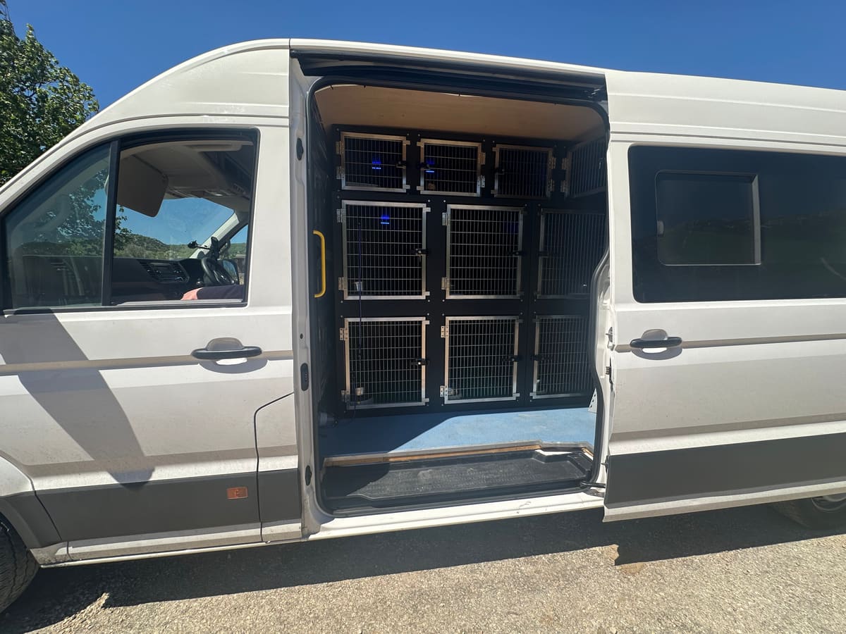 Above Board Pet Travel van with side door open showing secure travel crates